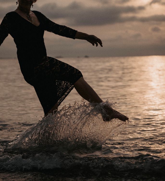 Woman in Black Dress Kicking the Water Free Stock Photo Woman in Black Dress Kicking the Water Free Stock Photo