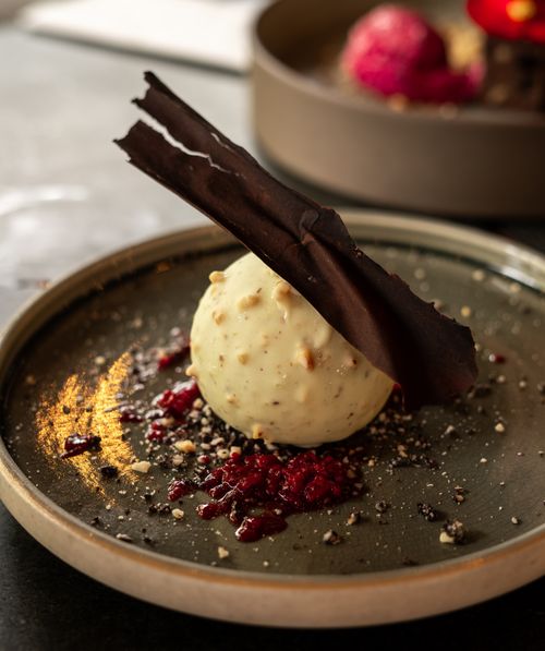 Free Elegant gourmet dessert featuring white chocolate and raspberry in Cluj-Napoca. Stock Photo