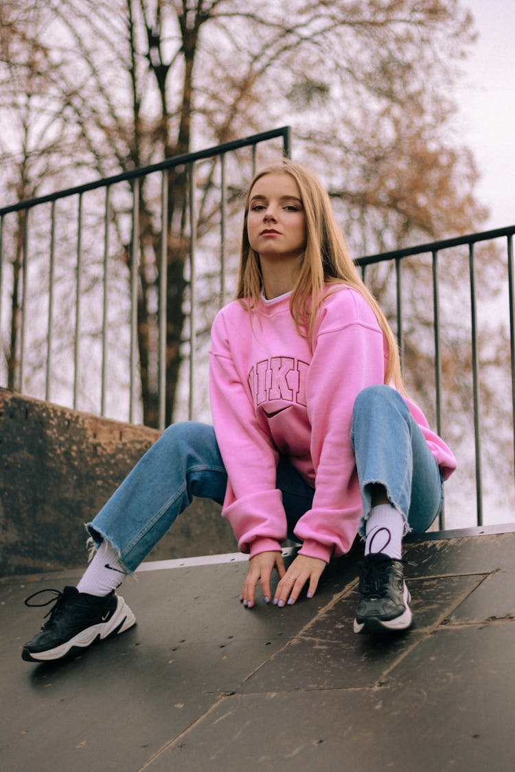 Blond Haired Woman In Pink Sweatshirt