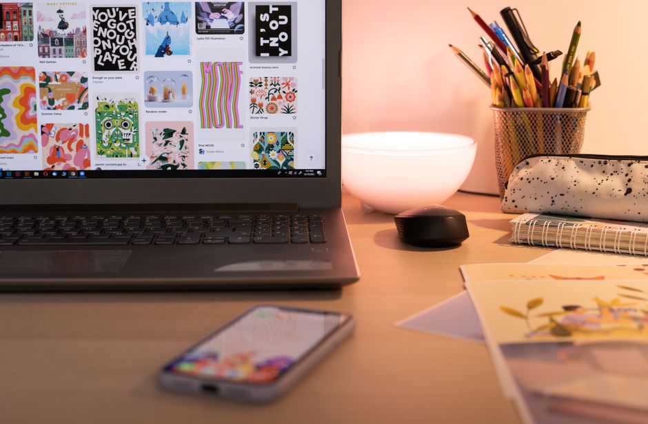 Canva vs Adobe Express: YouTube Thumbnail Text Overlay Showdown A cozy desk setup with art supplies, laptop, and smartphone, ideal for creative work in Bucharest.