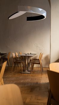 Cozy modern café interior in Bucharest featuring wooden furniture and minimalist design.