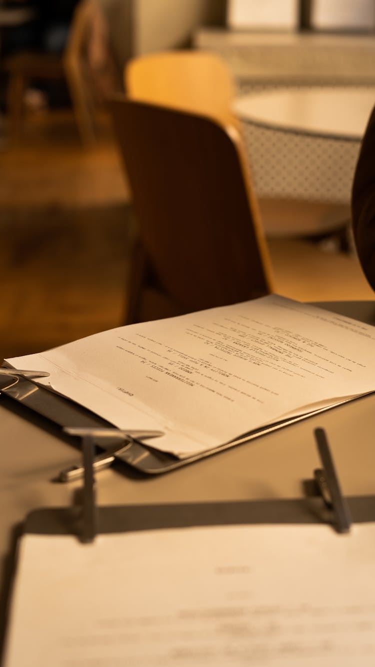 A Menu In A Clipboard On A Table