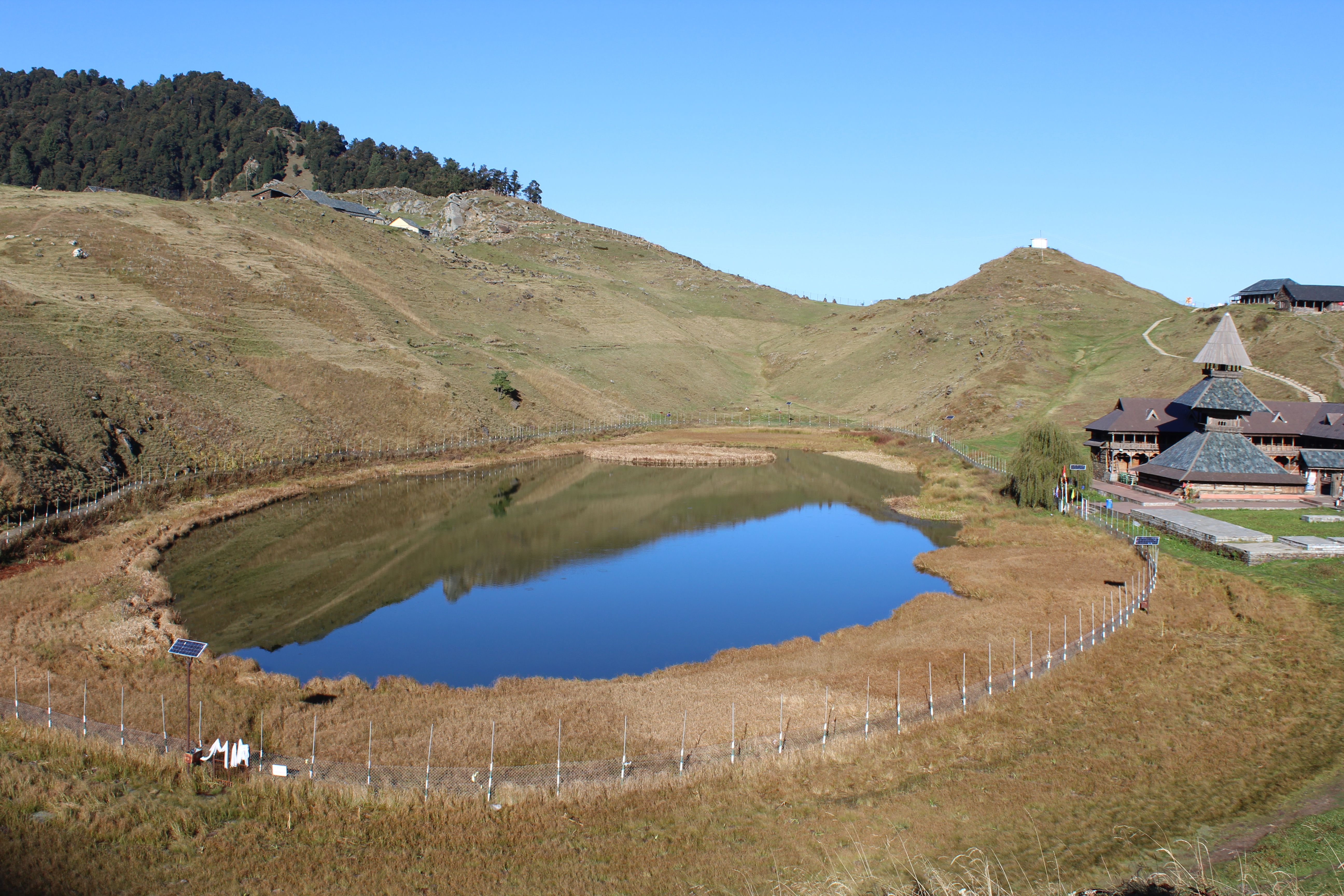 A breathtaking aerial shot capturing Prashar Lake and the temple in serene surroundings at D.P.F. Parashar Dhar, Himachal Pradesh, India.