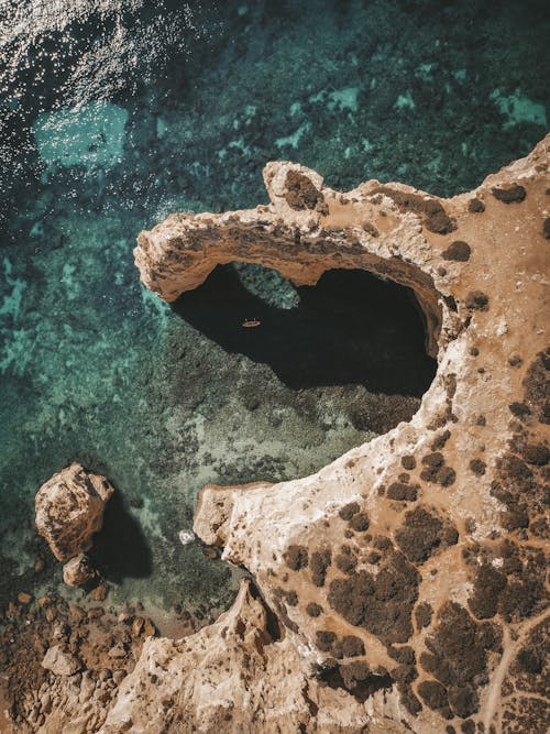 Aerial View of a Rocky Formation on Sea