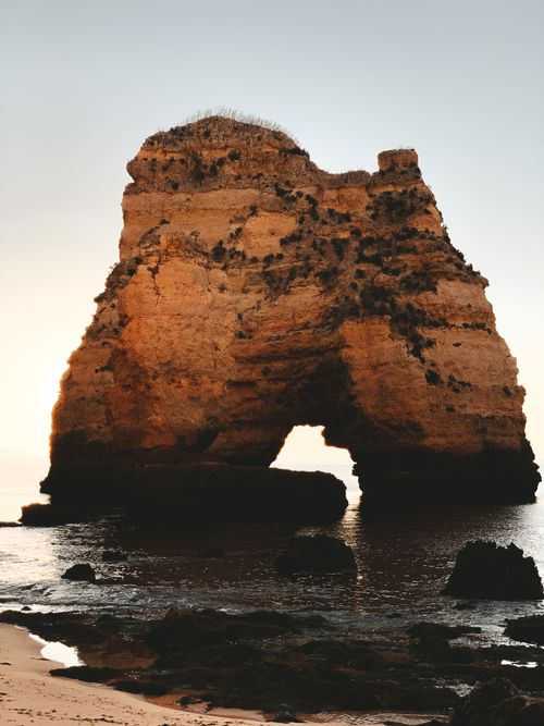 Free Stunning view of Algarve's iconic rock formation at sunset showcasing natural beauty. Stock Photo