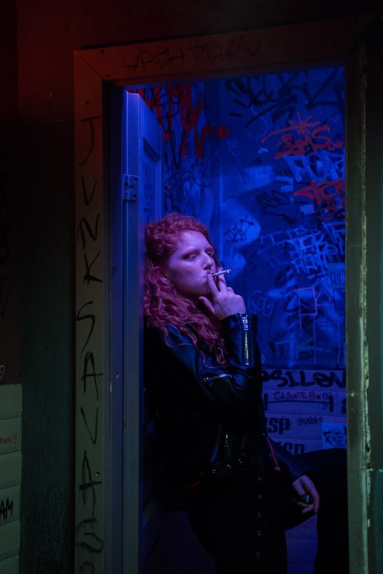 Woman Smoking In A Nightclub Bathroom Stall 