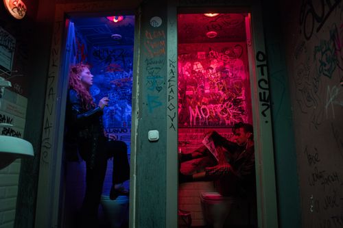 Free Punk-inspired image of individuals in vibrant, graffiti-covered restrooms, exuding rebellious energy. Stock Photo