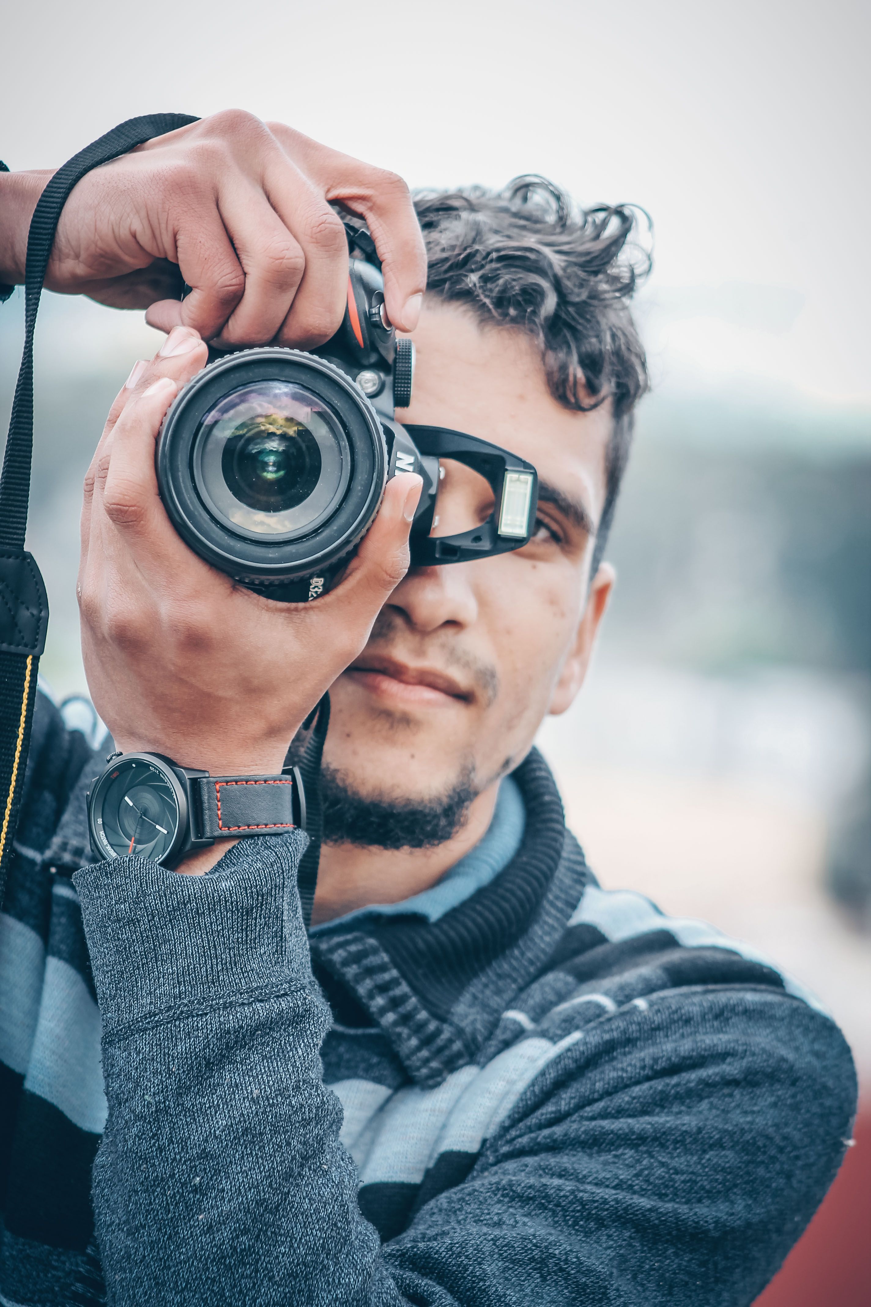 photo-of-man-holding-nikon-dslr-camera-free-stock-photo