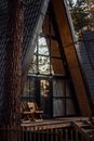 Front Window and Porch of Wooden Chalet in Pine Forest