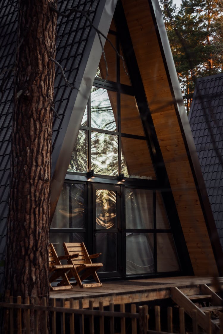 Front Window And Porch Of Wooden Chalet In Pine Forest