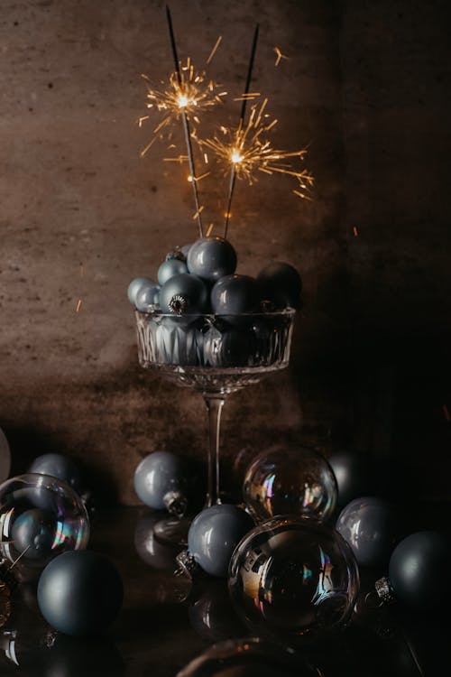 Silver and Black Baubles on Clear Glass Container