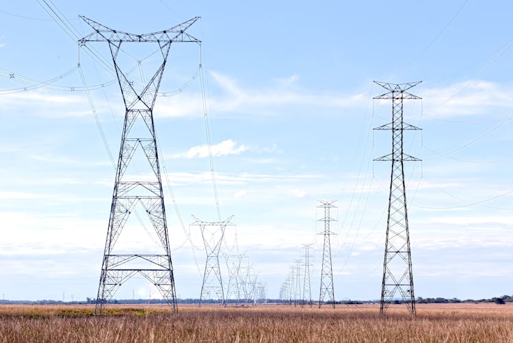 Electricity Pylons In A Field 