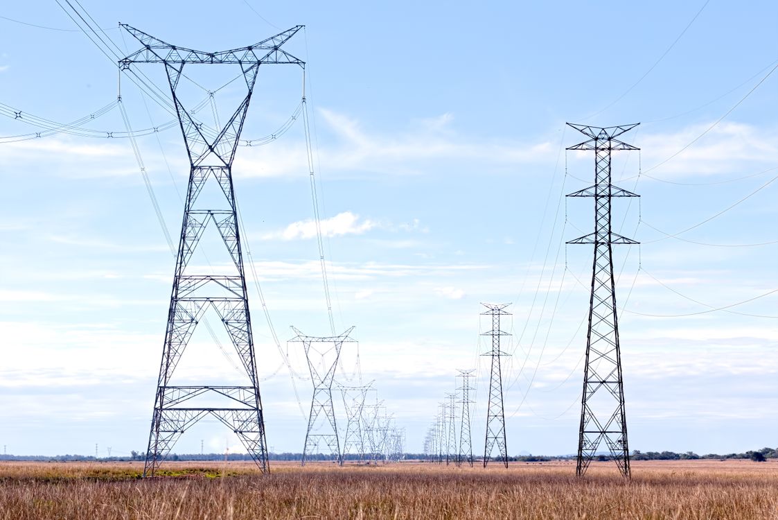 Electricity Pylons in a Field · Free Stock Photo