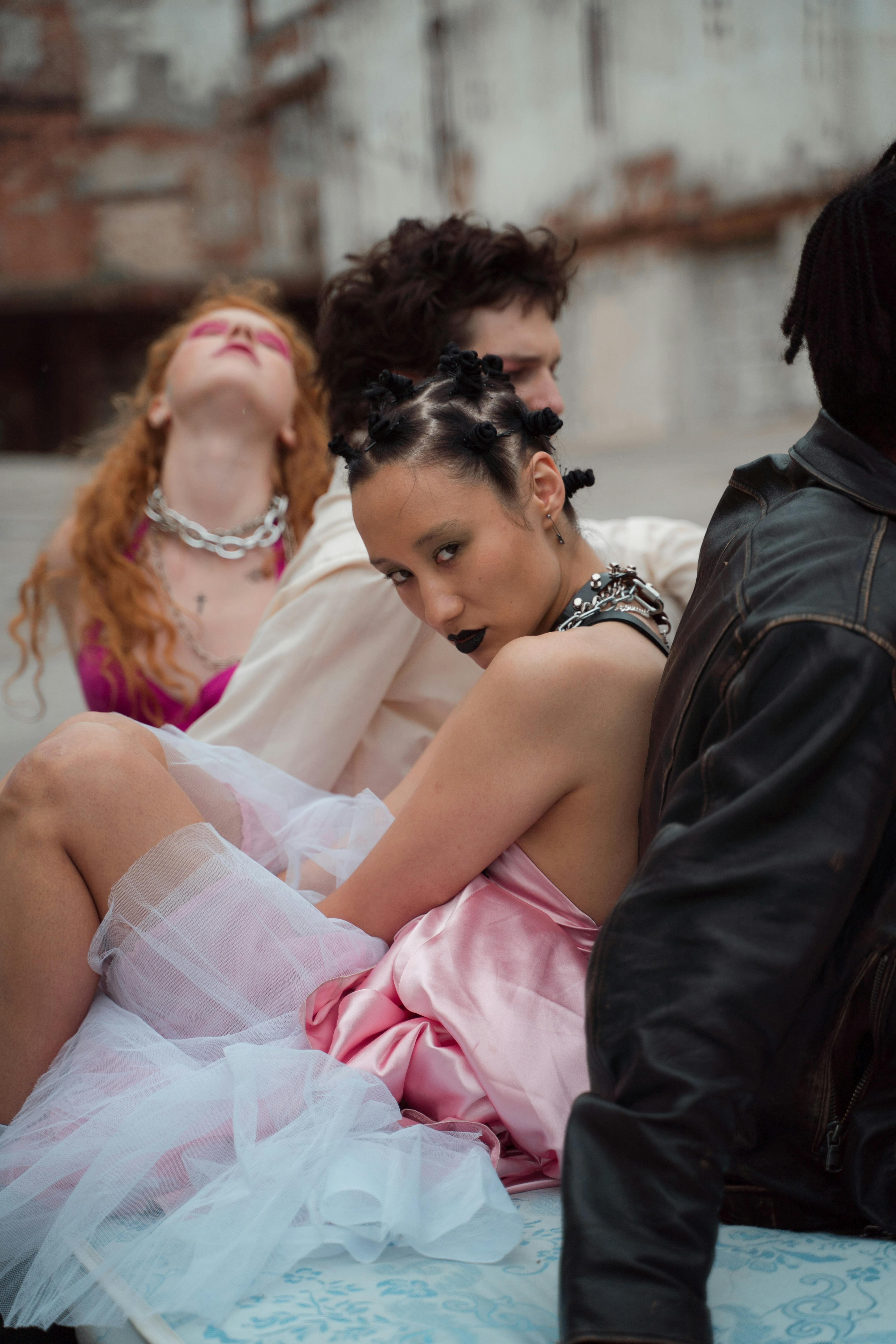 woman in pink dress sitting on blue mattress