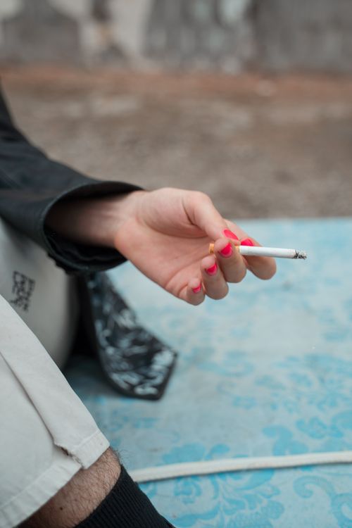 A Person Holding a Cigarette · Free Stock Photo