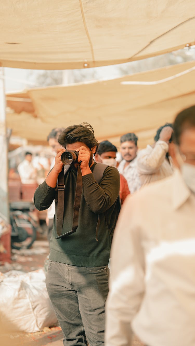 Man Photographing At The Market 