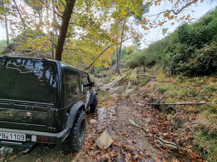 A Car Moving On A Dirt Road