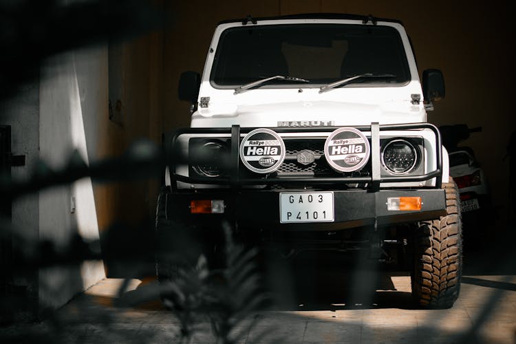 White 4x4 Car Parked On Garage 