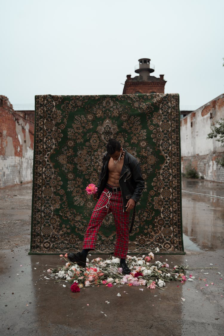 Man Looking Down While Stepping On Flowers