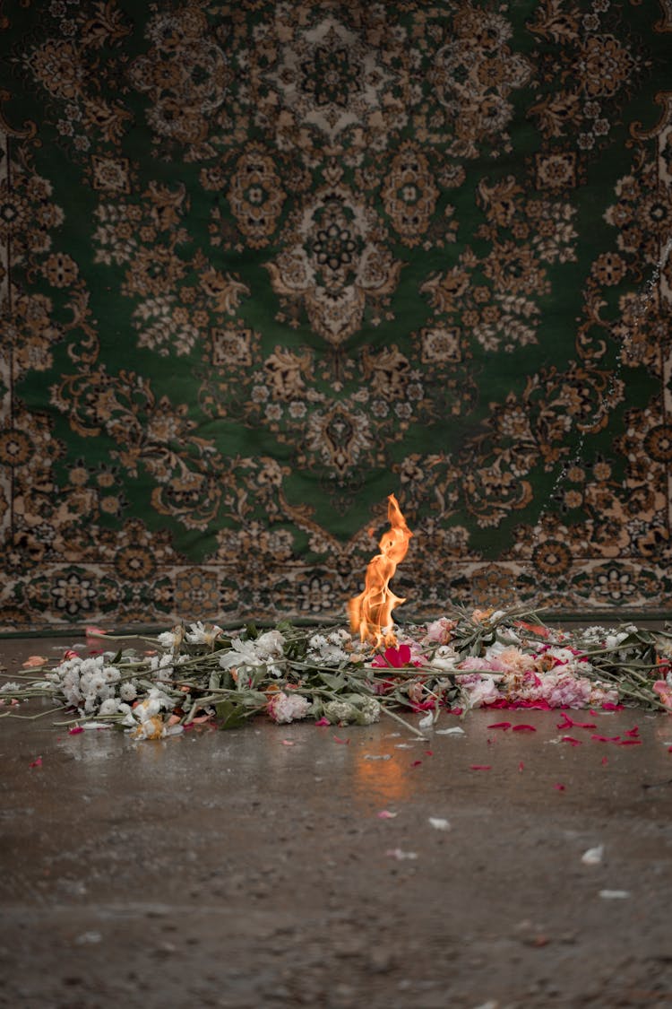 A Pile Of Flowers On Fire Near The Floral Carpet