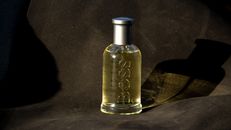 A Bottle of Boss Perfume on Black Fabric