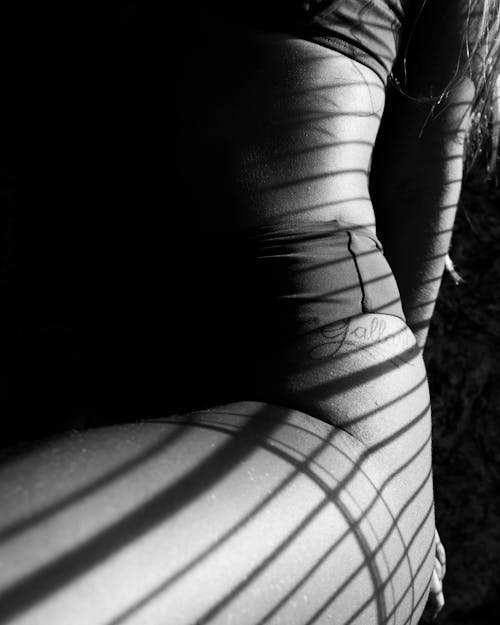 Grayscale Photo of Woman With Shadows on Her Body 