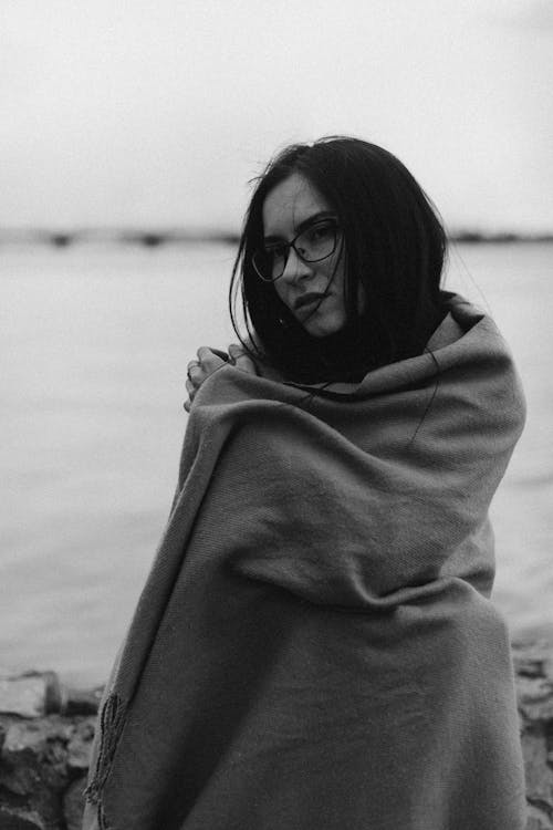Grayscale Photo of Woman Wrapped in Blanket