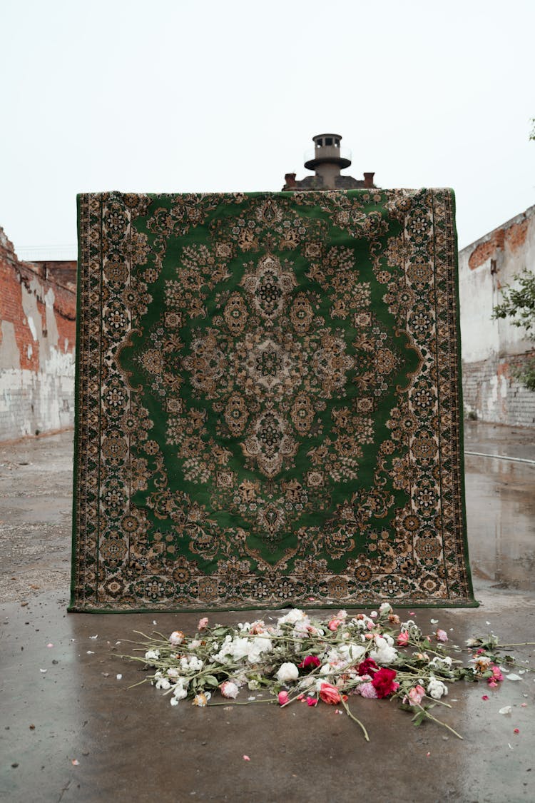 A Carpet With Scattered Flowers On The Ground