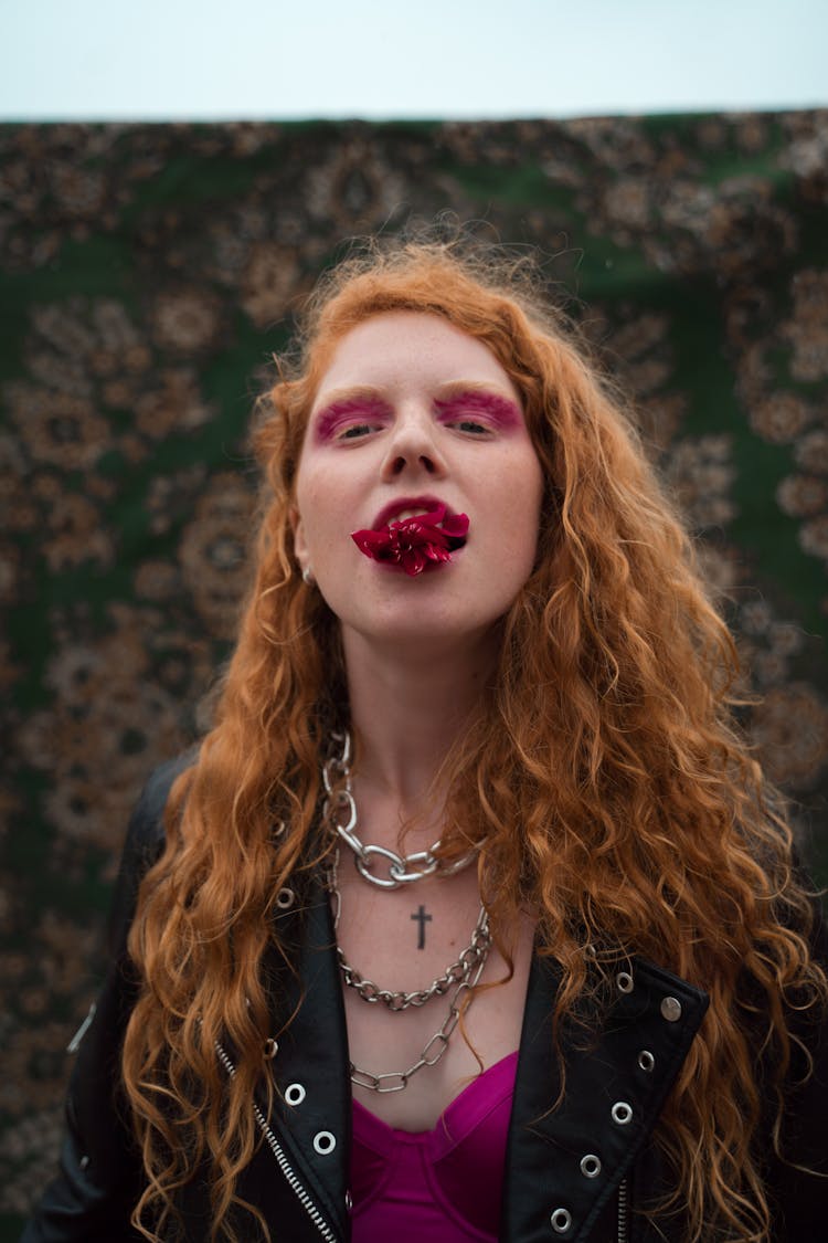 A Woman With A Flower On Her Mouth