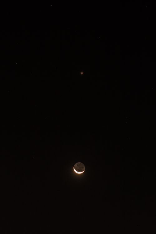 Free Close-up of crescent moon with stars visible in a dark night sky, perfect for celestial themes. Stock Photo