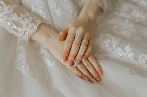 Hands of Bride in Wedding Dress