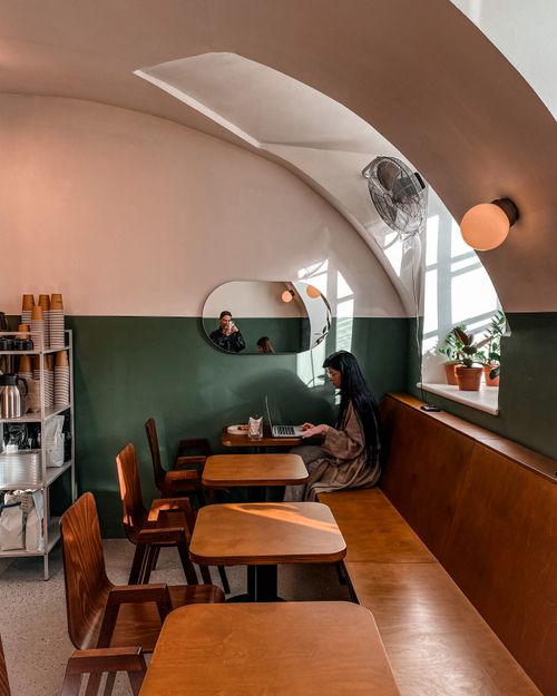 Free A woman working on her laptop in a stylish Saint Petersburg café. Stock Photo