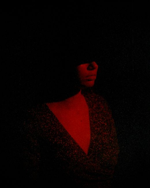 Artistic silhouette portrait in red light, highlighting mood and mystery.