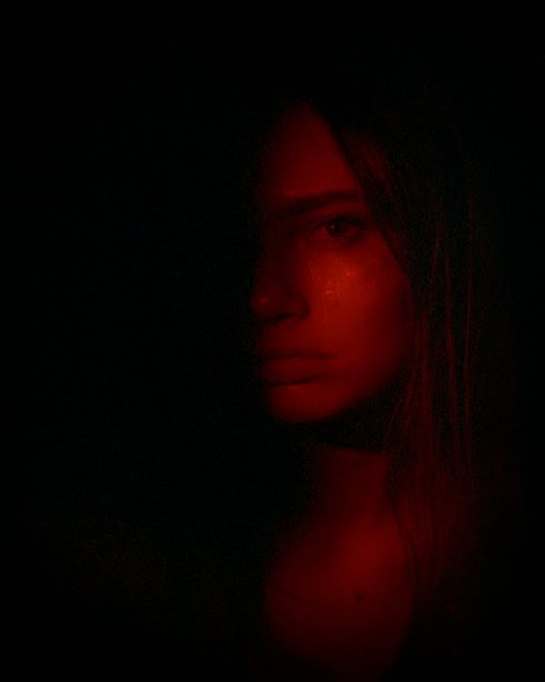 Half of Woman's Face in Red Light
