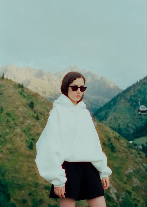 Teenage Girl Wearing Short Skirt and Blouse in Mountains