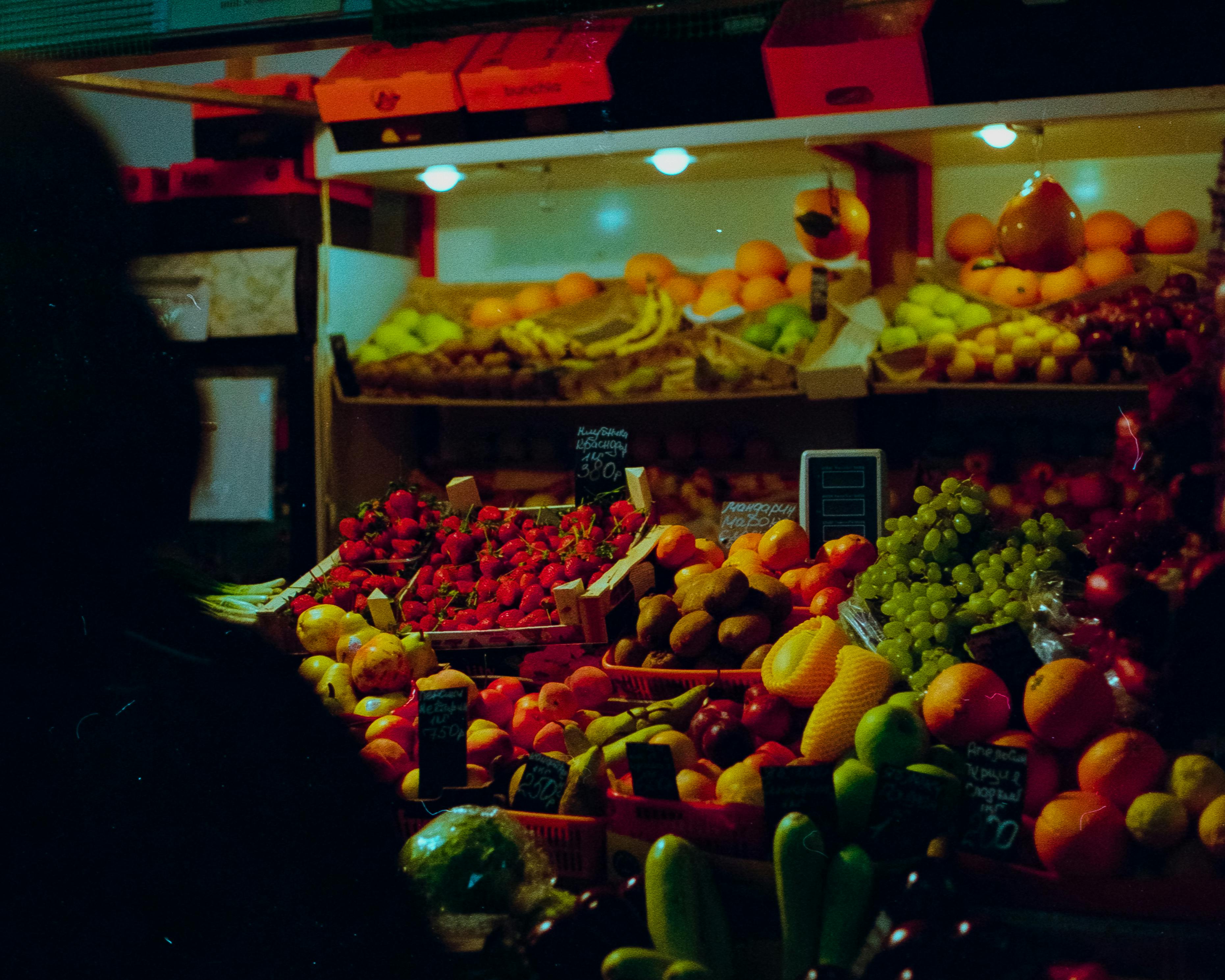 Colorful display of fresh fruits at a bustling Moscow marketplace. Ideal for food and travel themes.