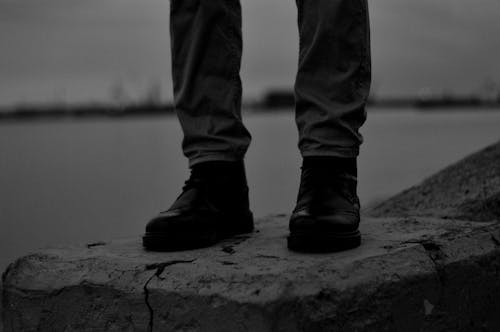 Free Grayscale Photo of a Person in Black Shoes Stock Photo