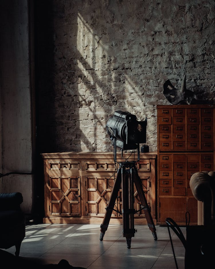 Vintage Tripod Reflector Standing In Eclectic Interior