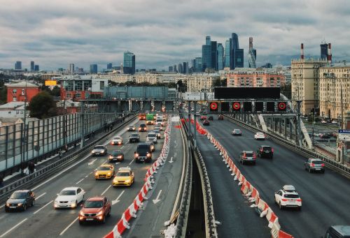 Free Busy highway scene in Moscow with skyscrapers in the background, showcasing urban traffic flow. Stock Photo