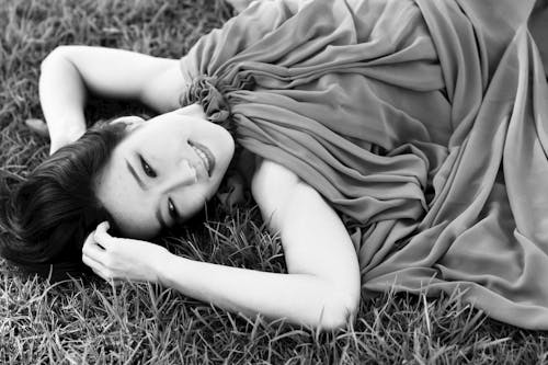 Close-Up Shot of a Woman Lying Down on the Grass