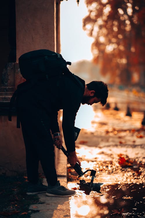 A Bearded Man Using a Camera with a Gimbal