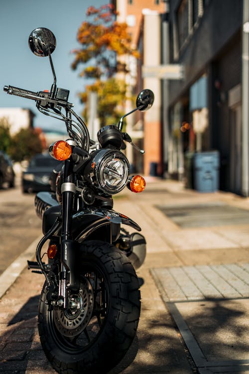 Close-Up Shot of a Motorcycle Parked on the Sidewalk