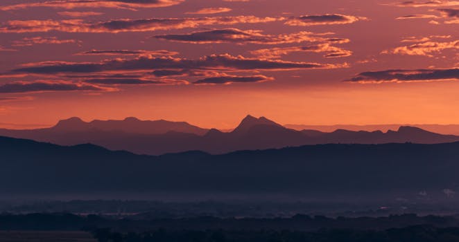 Breathtaking view of the sunrise casting an orange hue over a Colombian mountain range.