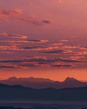 Vibrant sunrise over Colombian mountains with stunning orange and pink hues.