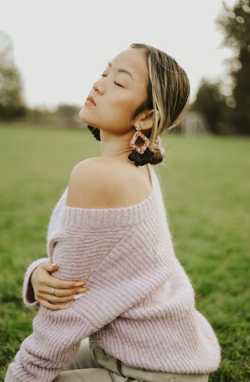 Portrait of Woman Sitting on Grass with Eyes Closed