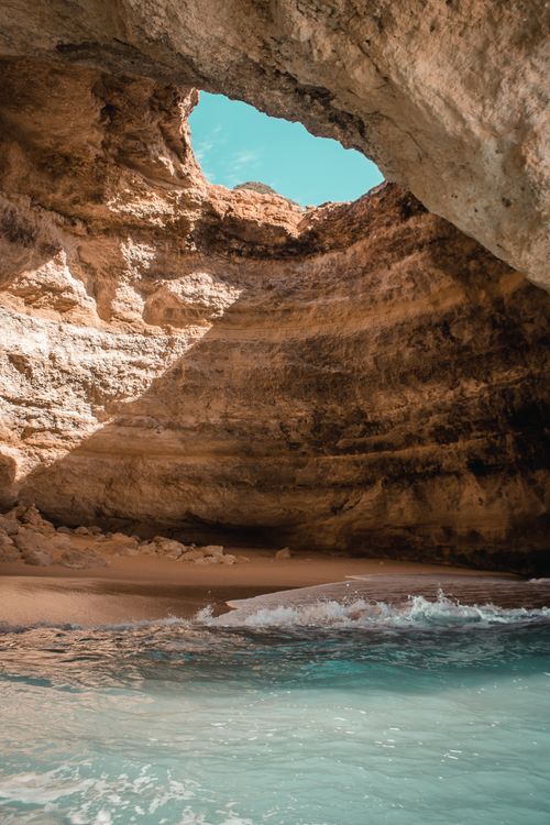 Free Captivating view of a beach cave in Algarve with turquoise waters and rock formations. Stock Photo