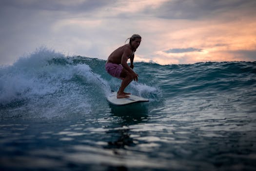 A surfer skillfully rides a wave during sunset in Bali, capturing the essence of adventure and natural beauty.
