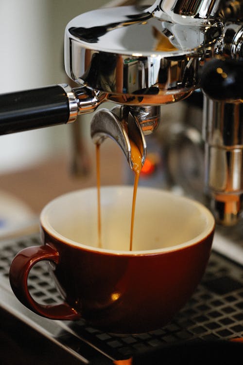 Free Espresso Pouring from Coffee Machine to Cup Stock Photo