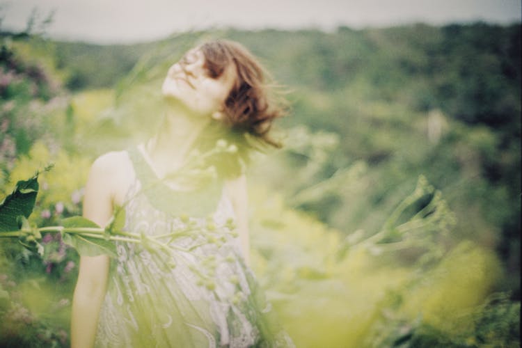 Pregnant Woman On A Field In Summer 