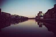 黄昏时分的城市河滨宁静，倒映着建筑的轮廓